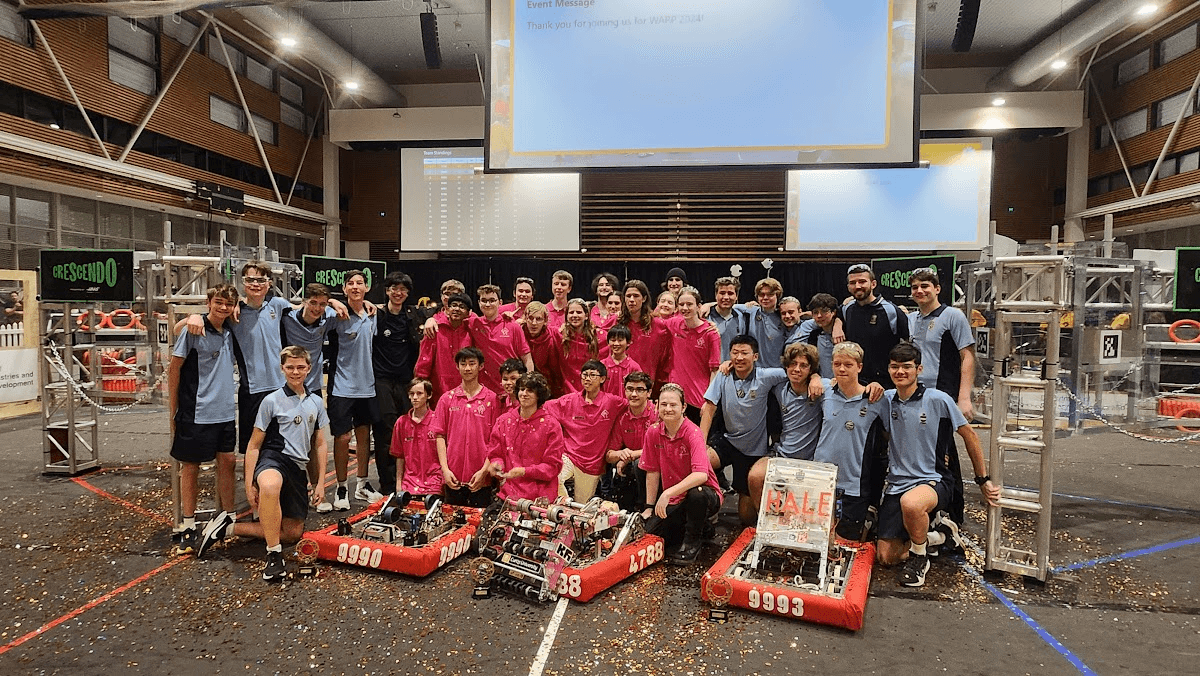 Group photo of teams and their robots at an event