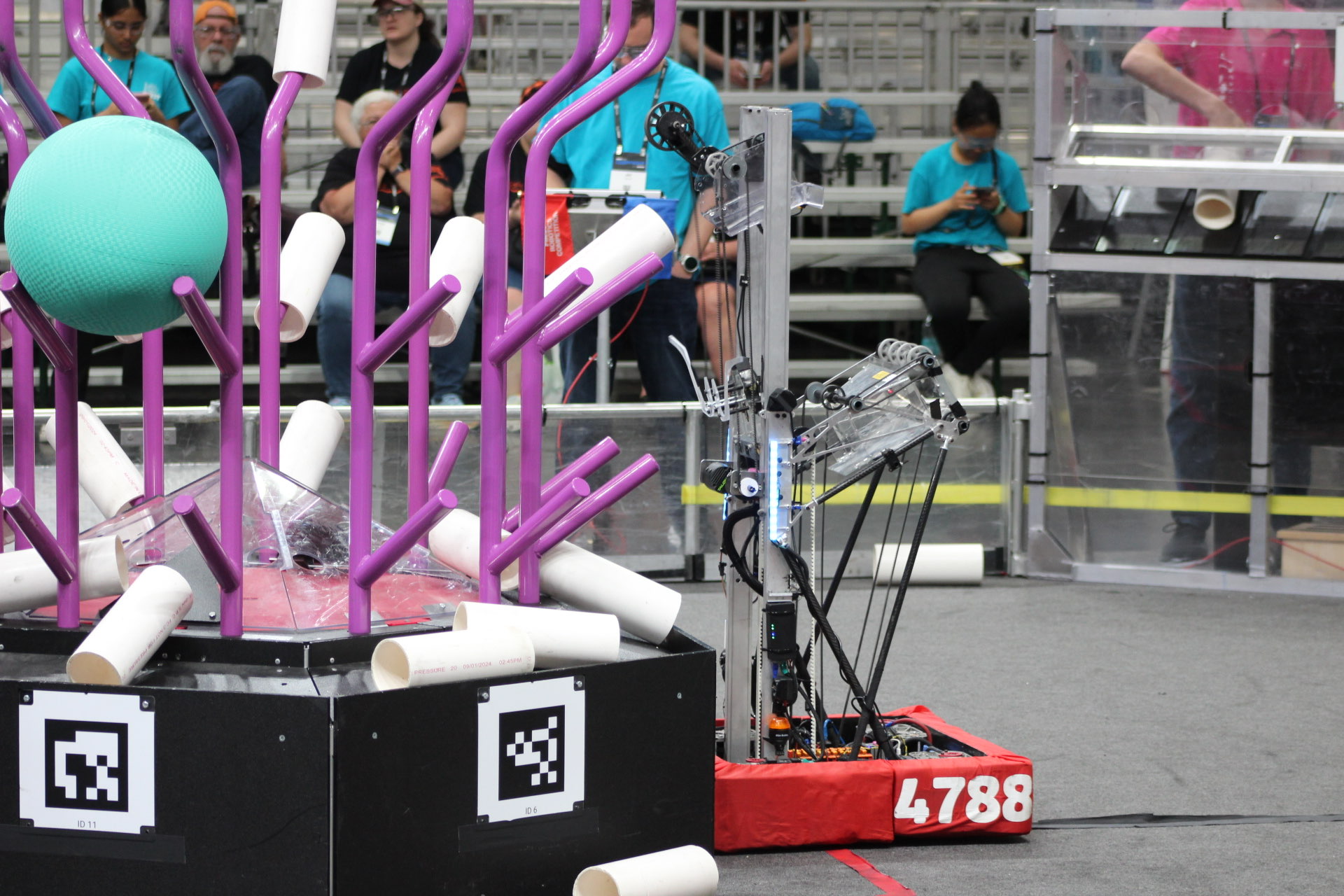 Team 4788's robot beside the reef on a Reefscape field