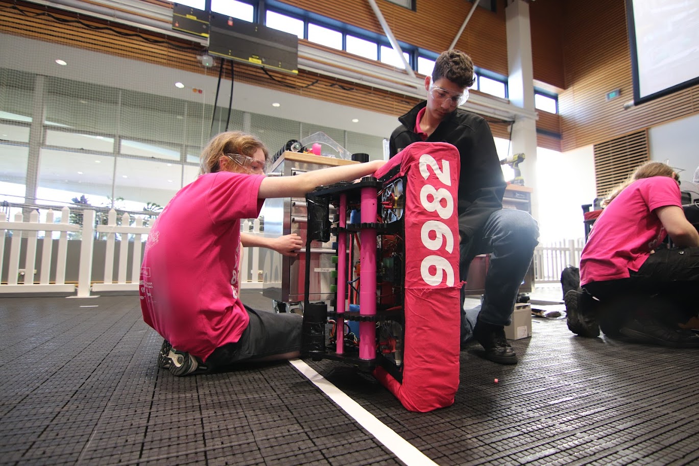 Team members working on robot 9982 in the pits