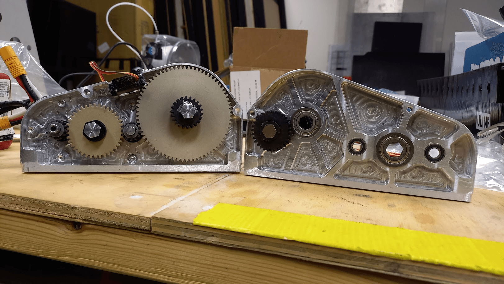 Two open gearboxes on a workbench